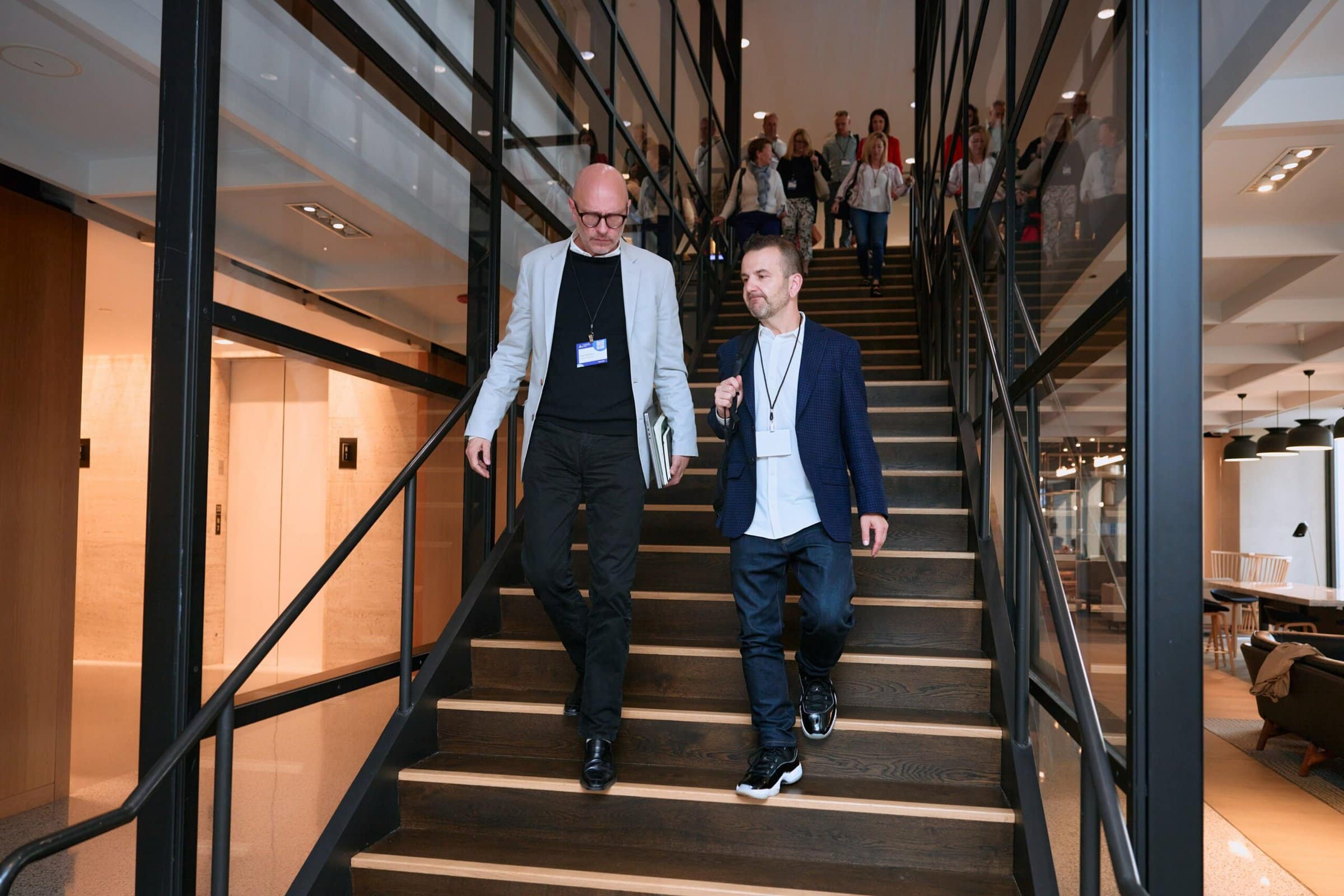 Couple of people chatting walking down stairs Couple of people chatting walking down stairs
