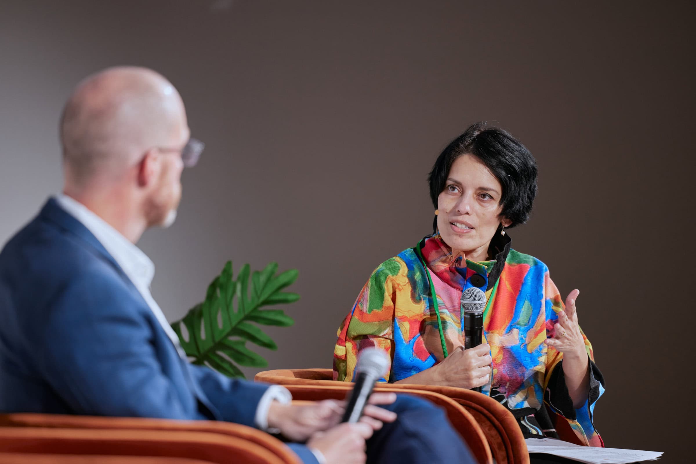 Close up of woman speaking into a microphone at a business panel at 4As event